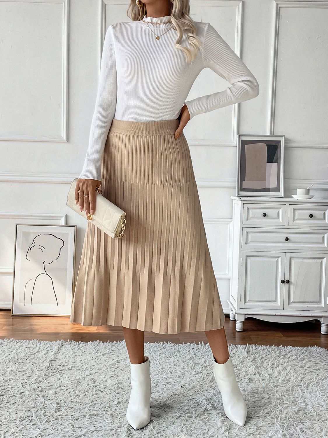 Perfee Pleated Midi Sweater Skirt in beige, featuring a stretchy, basic style, made from viscose, polyamide, and polyester, displayed in a stylish room setting.
