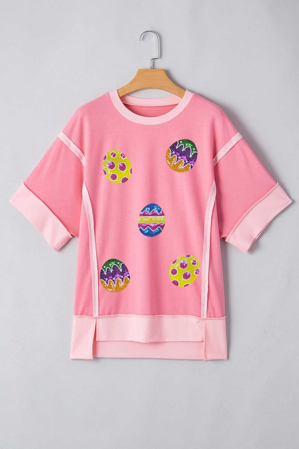 Pink sequined Easter egg short sleeve t-shirt with exposed seams.