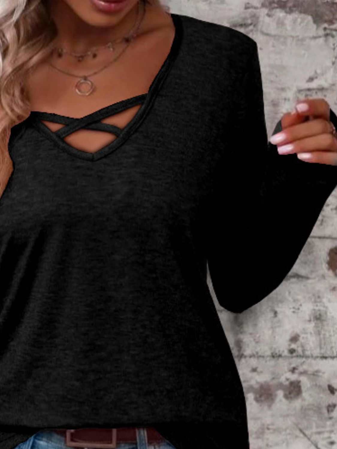 Crisscross V-neck long sleeve black T-shirt with slightly stretchy fabric.