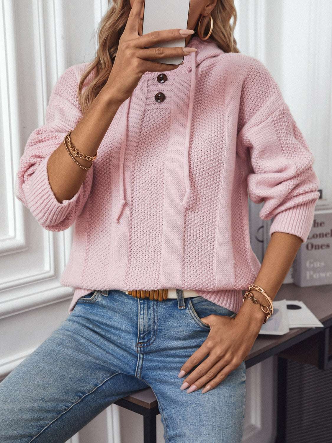 Drawstring long sleeve hooded sweater with decorative buttons in pink, slightly stretchy polyester.