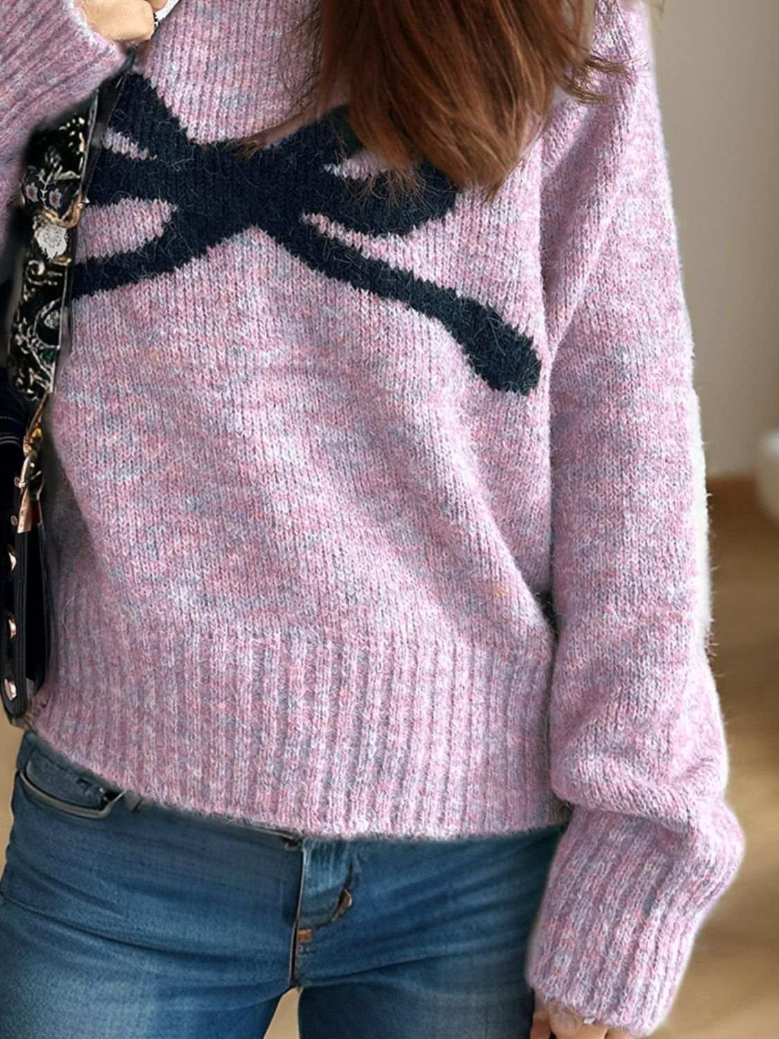 Bow round neck long sleeve sweater in pink with a bow design.