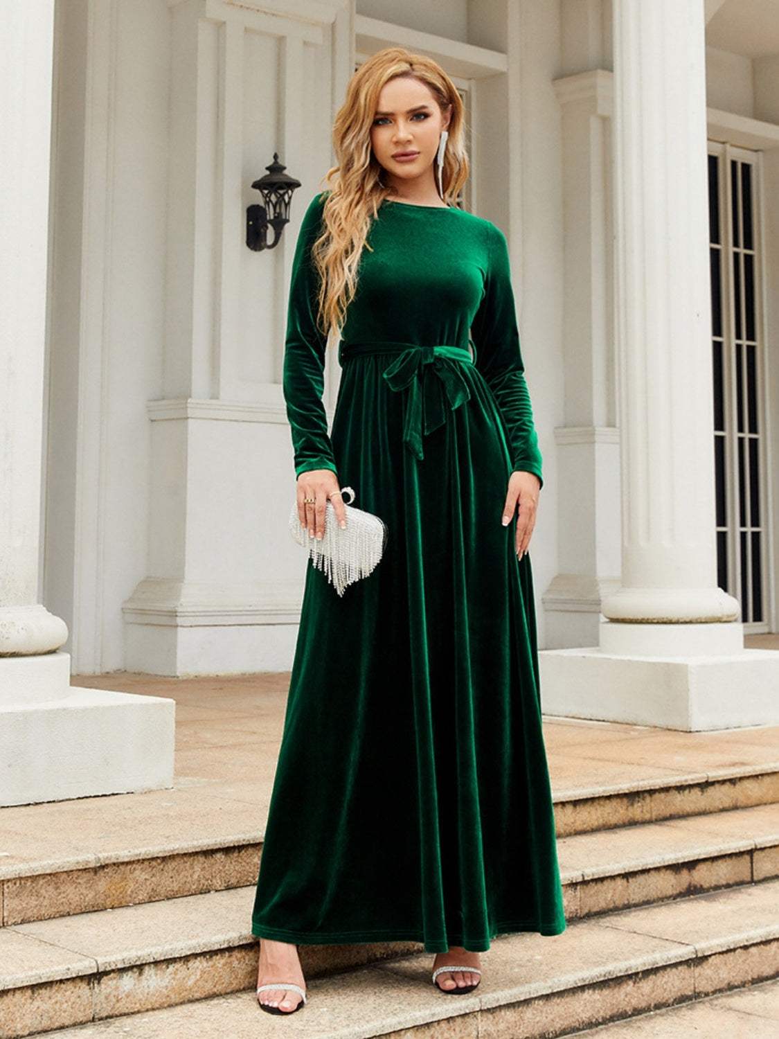 Tie Front Round Neck Long Sleeve Maxi Dress in green polyester with slight stretch, shown on model standing outside.