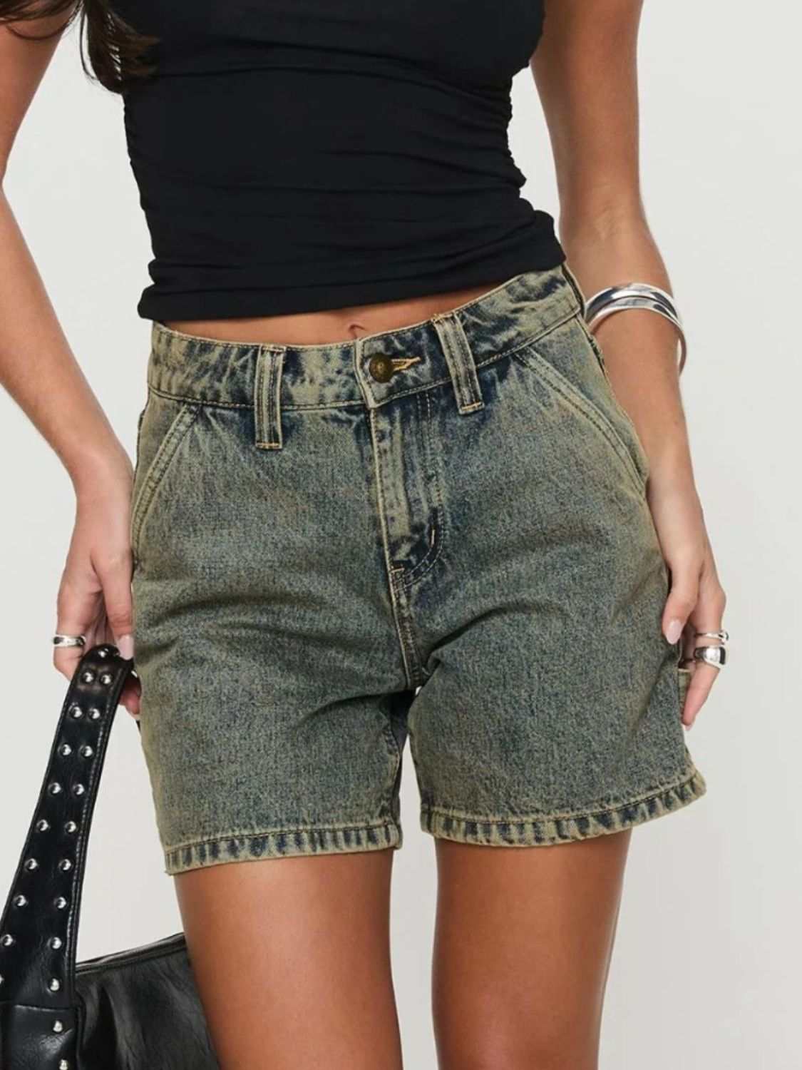 Washed high rise denim shorts with pockets, featuring no stretch and composed of 95% rayon and 5% polyester.