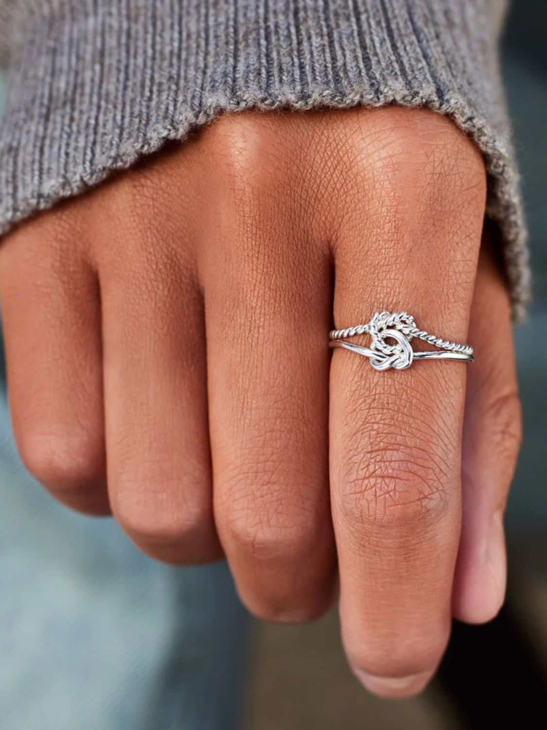 Adjustable 925 sterling silver knotted ring on hand.