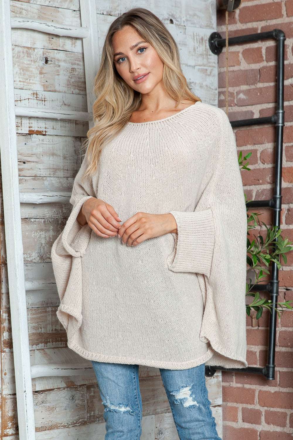 Round neck batwing sleeve sweater in beige, slightly stretchy with loose fit.