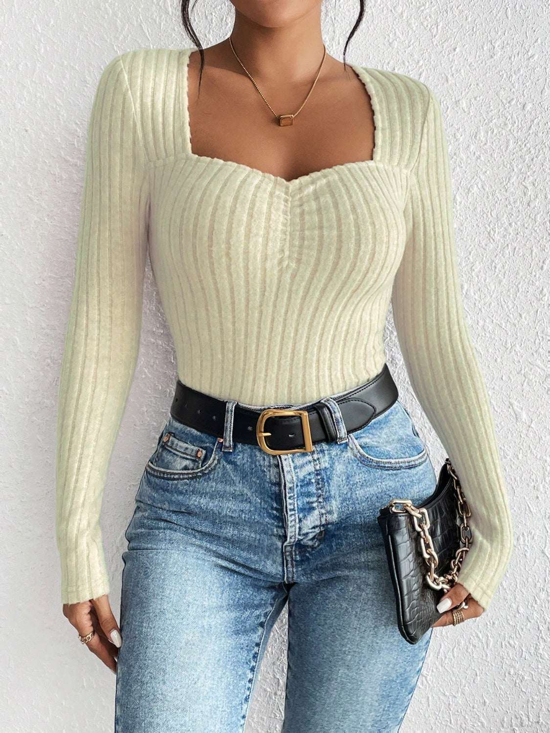 Honey ribbed long sleeve t-shirt with a square neckline, shown paired with jeans and a black belt.