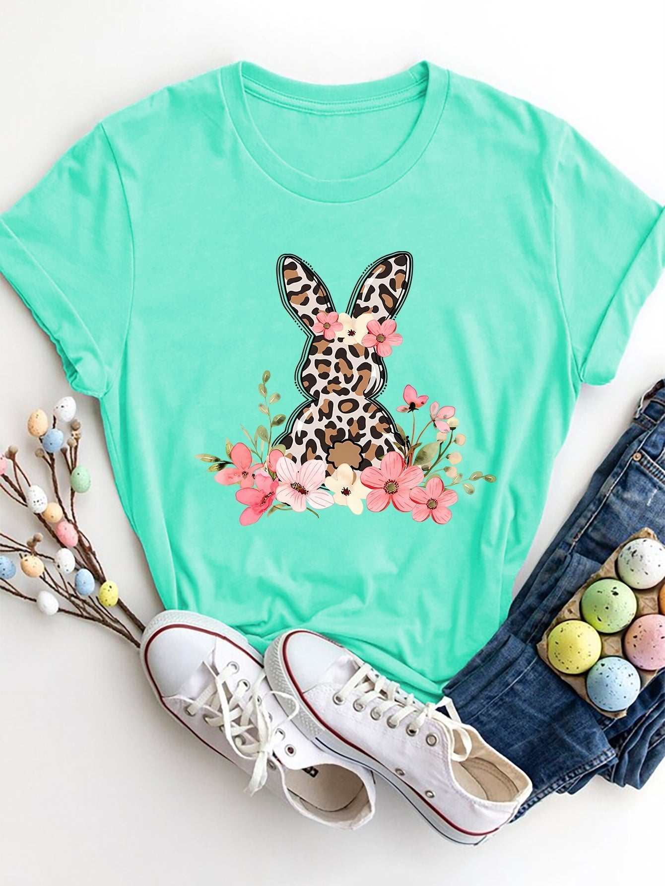 Rabbit round neck short sleeve T-shirt with floral design on mint green background.