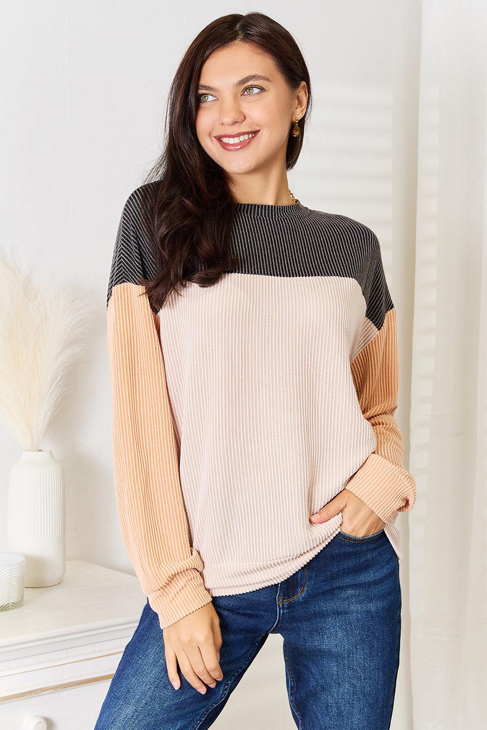 Color block dropped shoulder t-shirt with relaxed fit, worn with jeans, featuring a stylish and casual look.