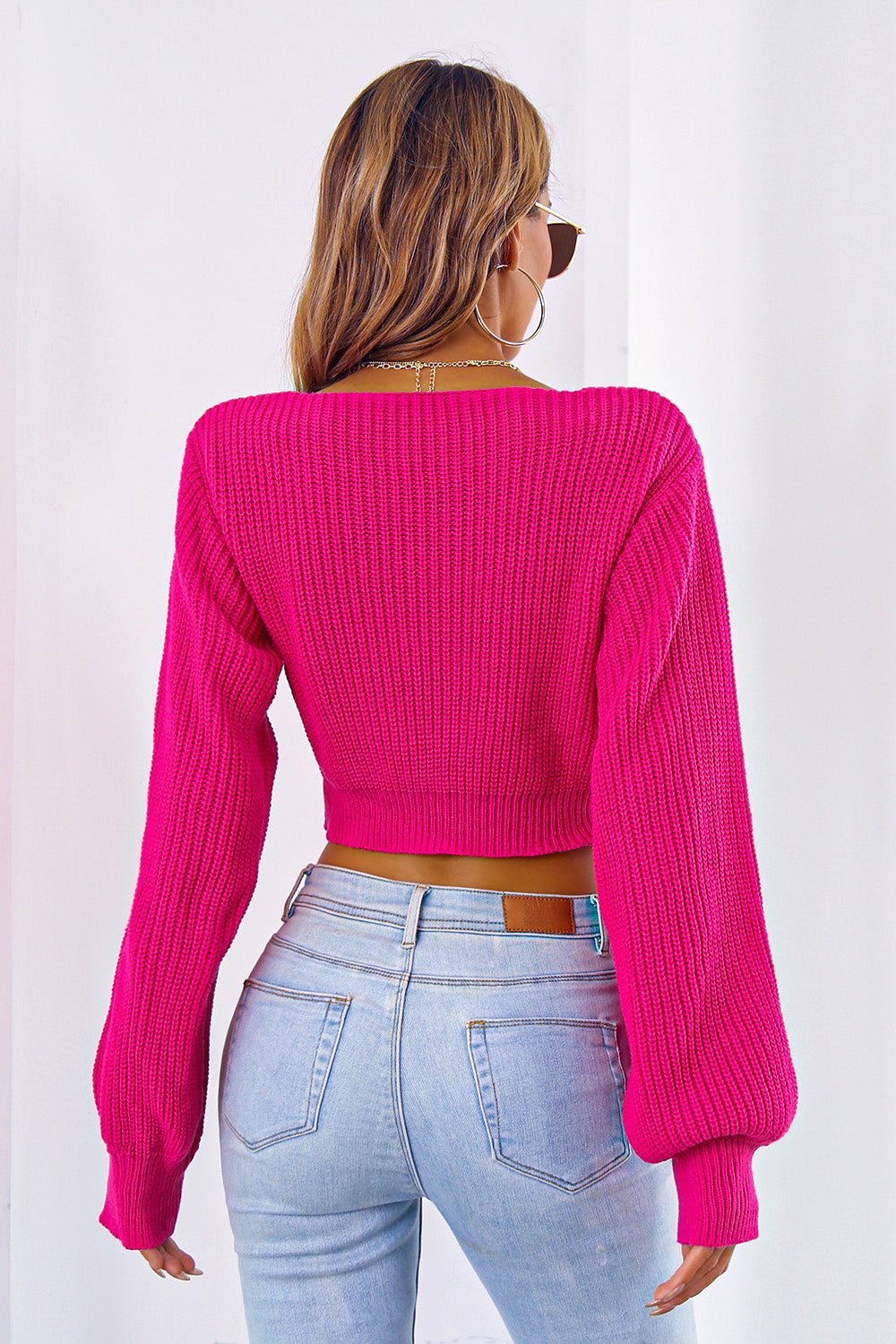 Bow V-Neck Long Sleeve Cropped Sweater in pink, back view.