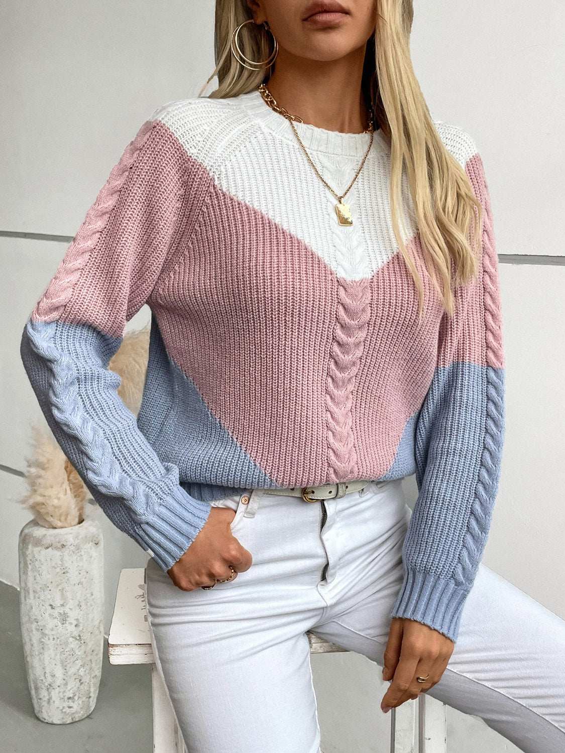 Color block round neck long sleeve sweater in pink, white, and blue.