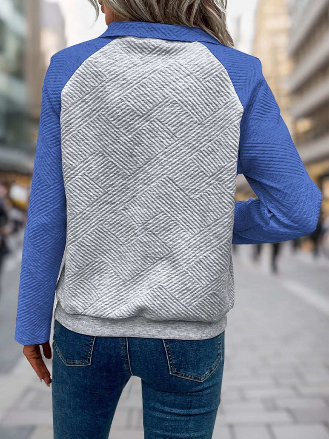 Perfee Contrast Textured Long Sleeve Sweatshirt with buttoned design and pockets worn outdoors.