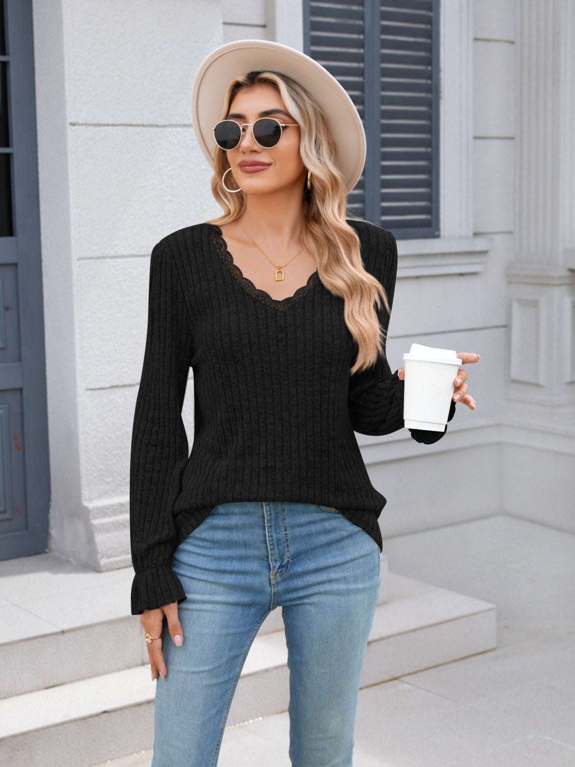 Lace detail V-neck long sleeve T-shirt in black, worn by woman with coffee cup and hat.