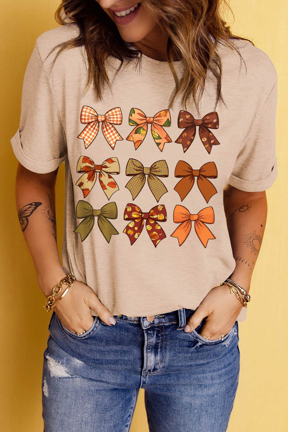 Bow graphic round neck short sleeve T-shirt with colorful bow designs.