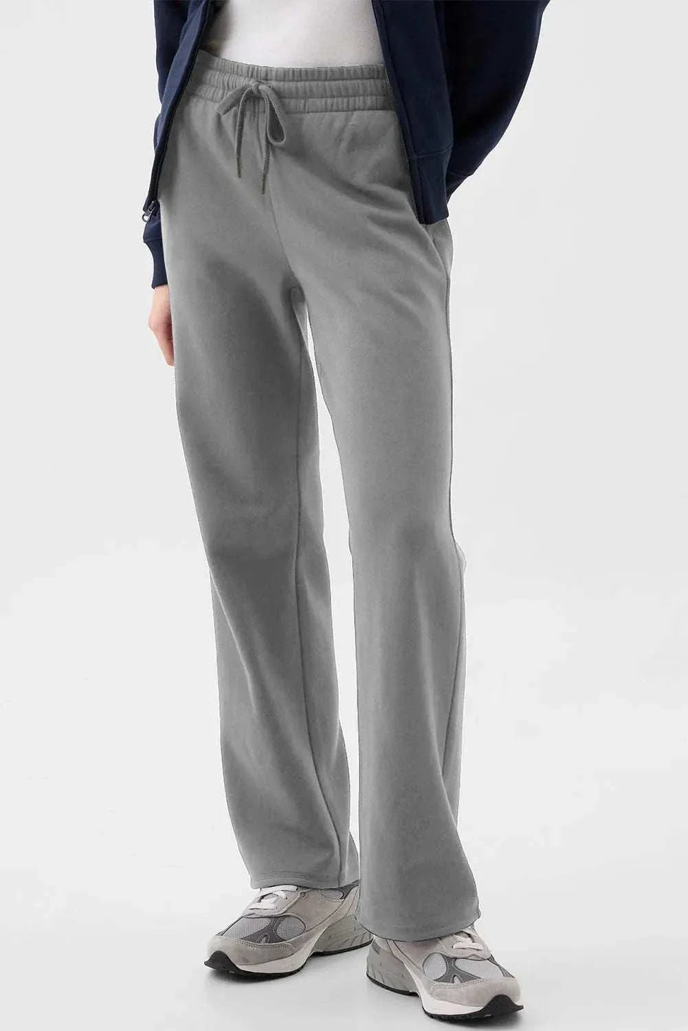 Gray drawstring pants with pockets, made of polyester and cotton.