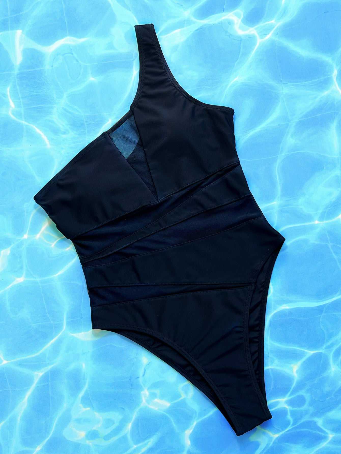 One-shoulder sleeveless one-piece swimsuit in solid color on a blue water background.