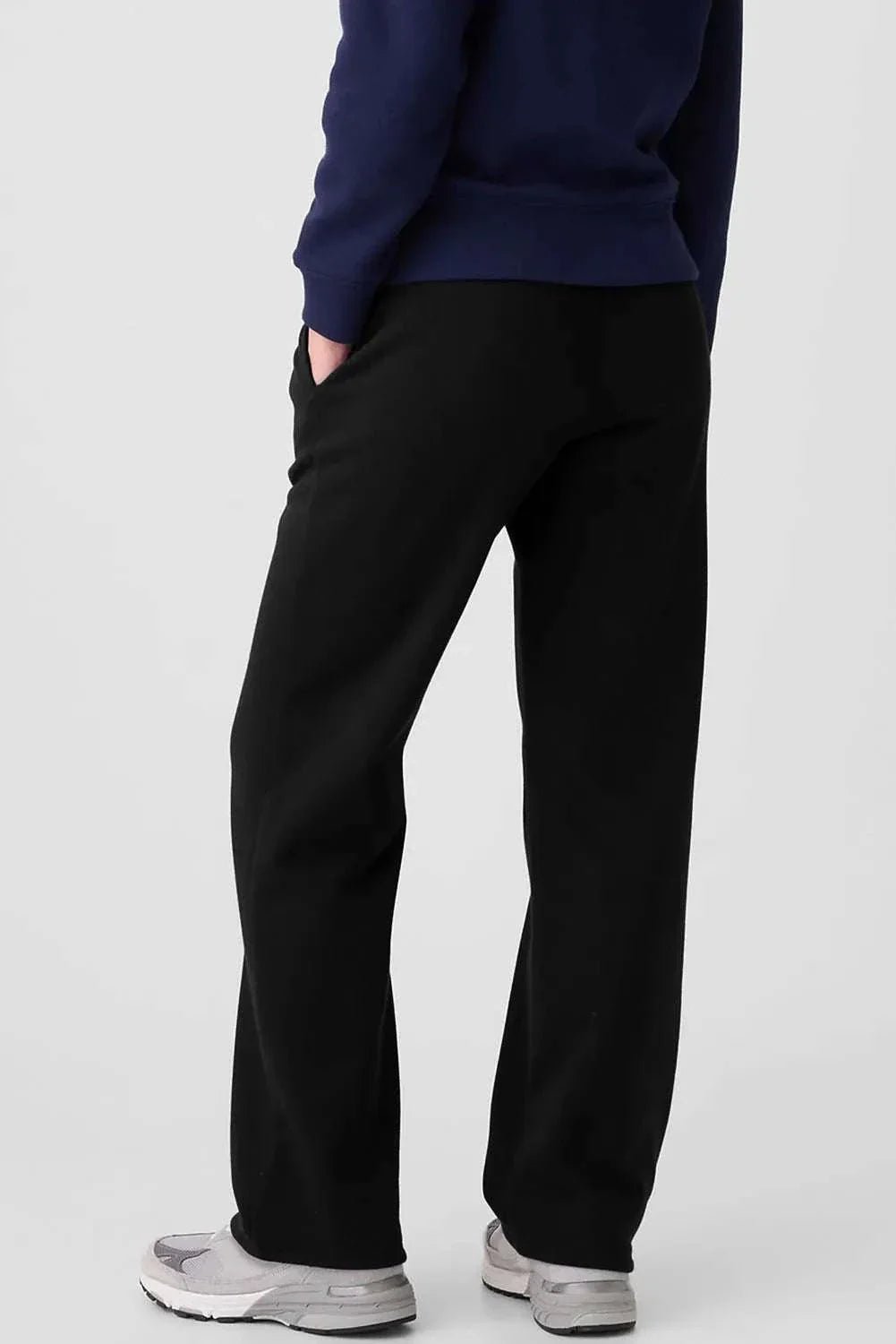 Black drawstring pants with pockets, made from polyester and cotton blend.
