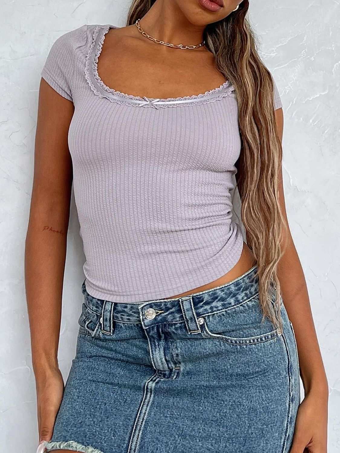 Scoop neck short sleeve t-shirt with lace detail and bow.