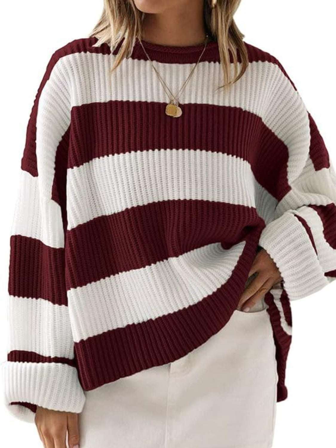 Red and white striped round neck long sleeve sweater made of 100% polyester.