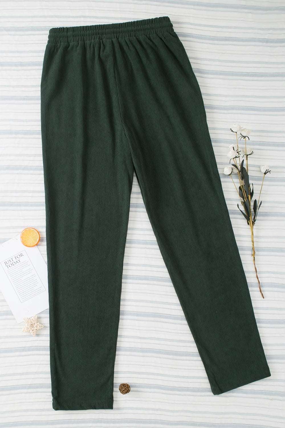 Drawstring straight pants with pockets in dark fabric.
