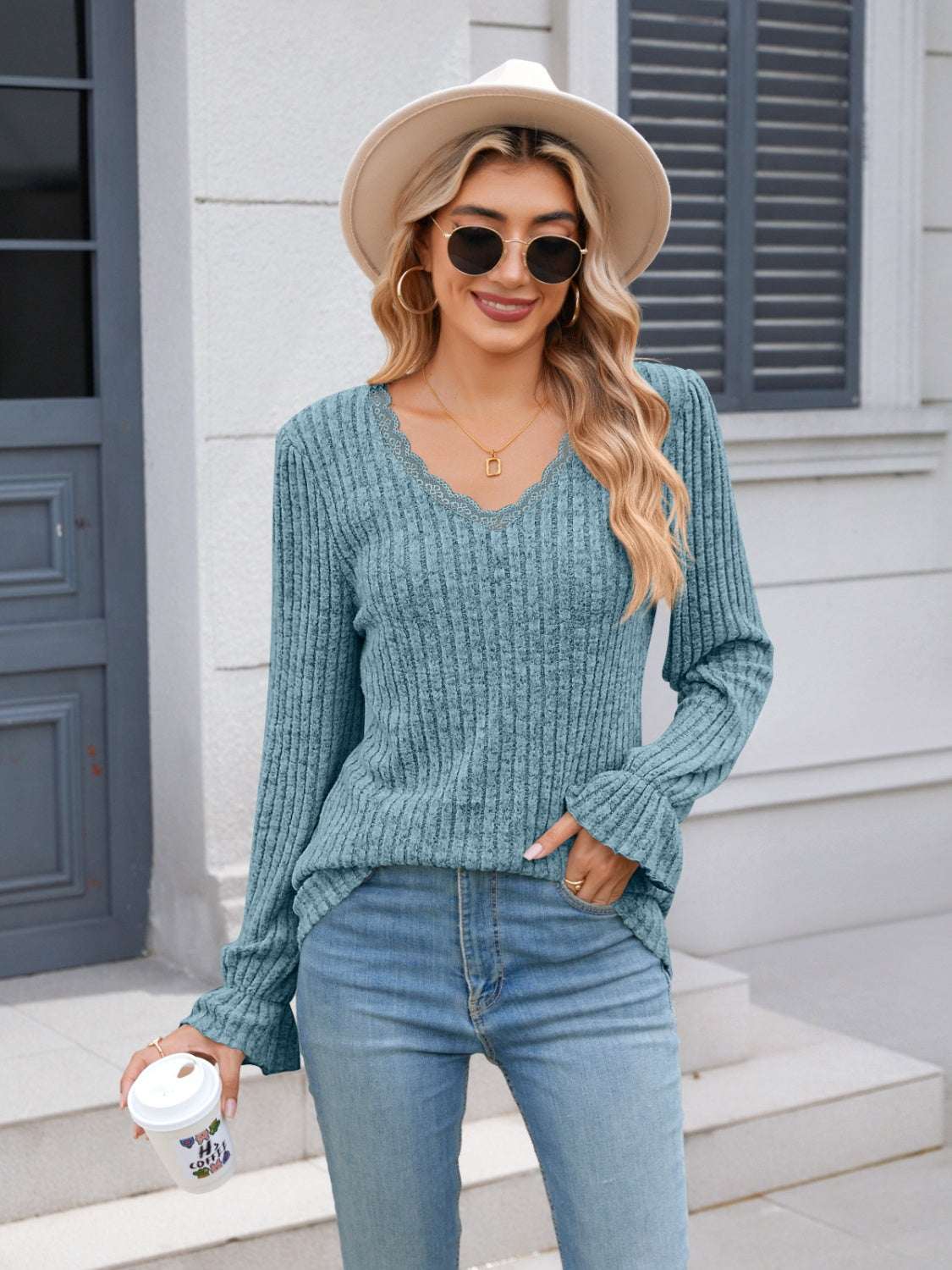 Lace Detail V-Neck Long Sleeve T-Shirt with ruffles in blue worn by woman outdoors.
