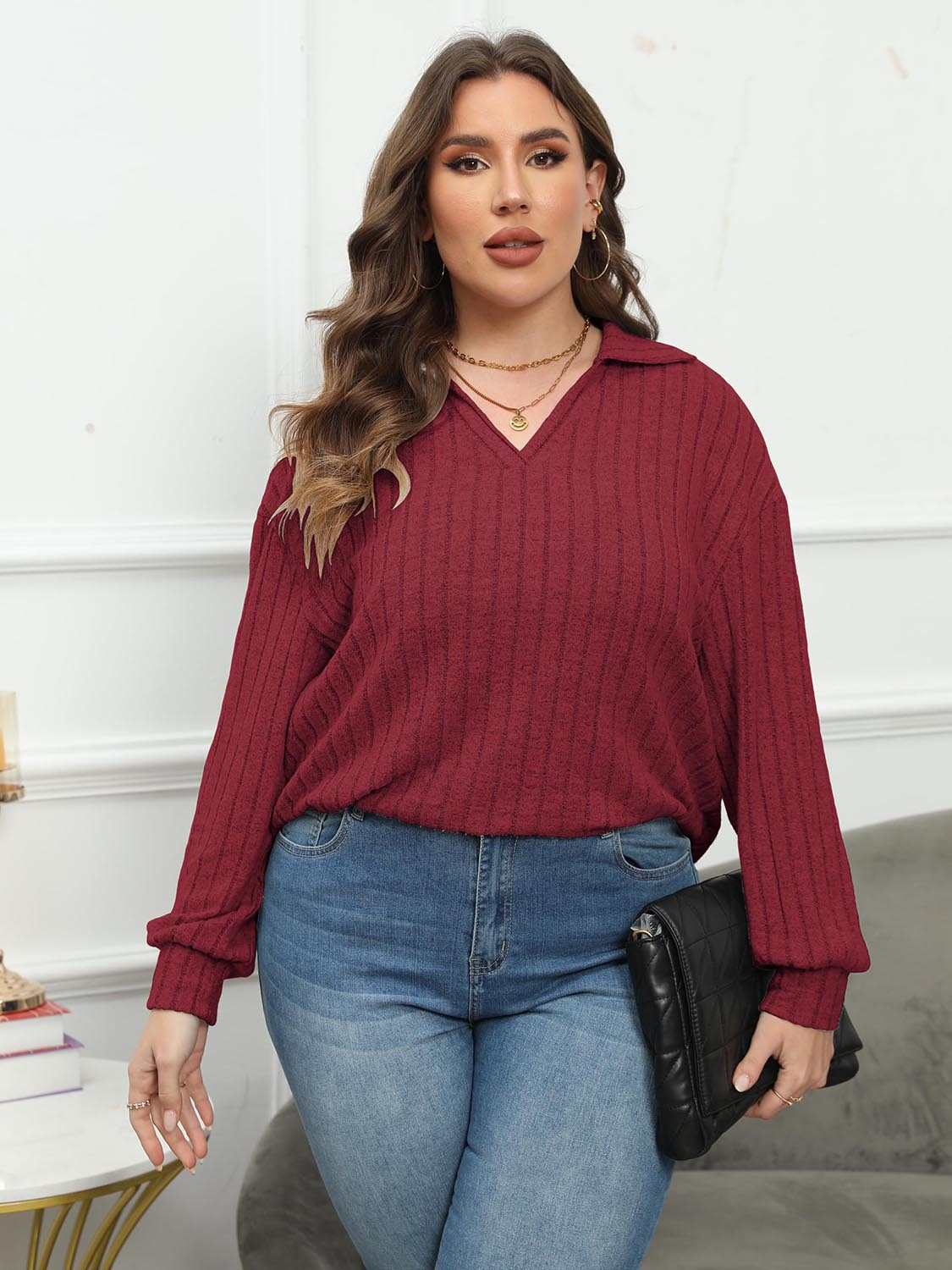 Plus size ribbed collared neck long sleeve blouse in burgundy worn with jeans