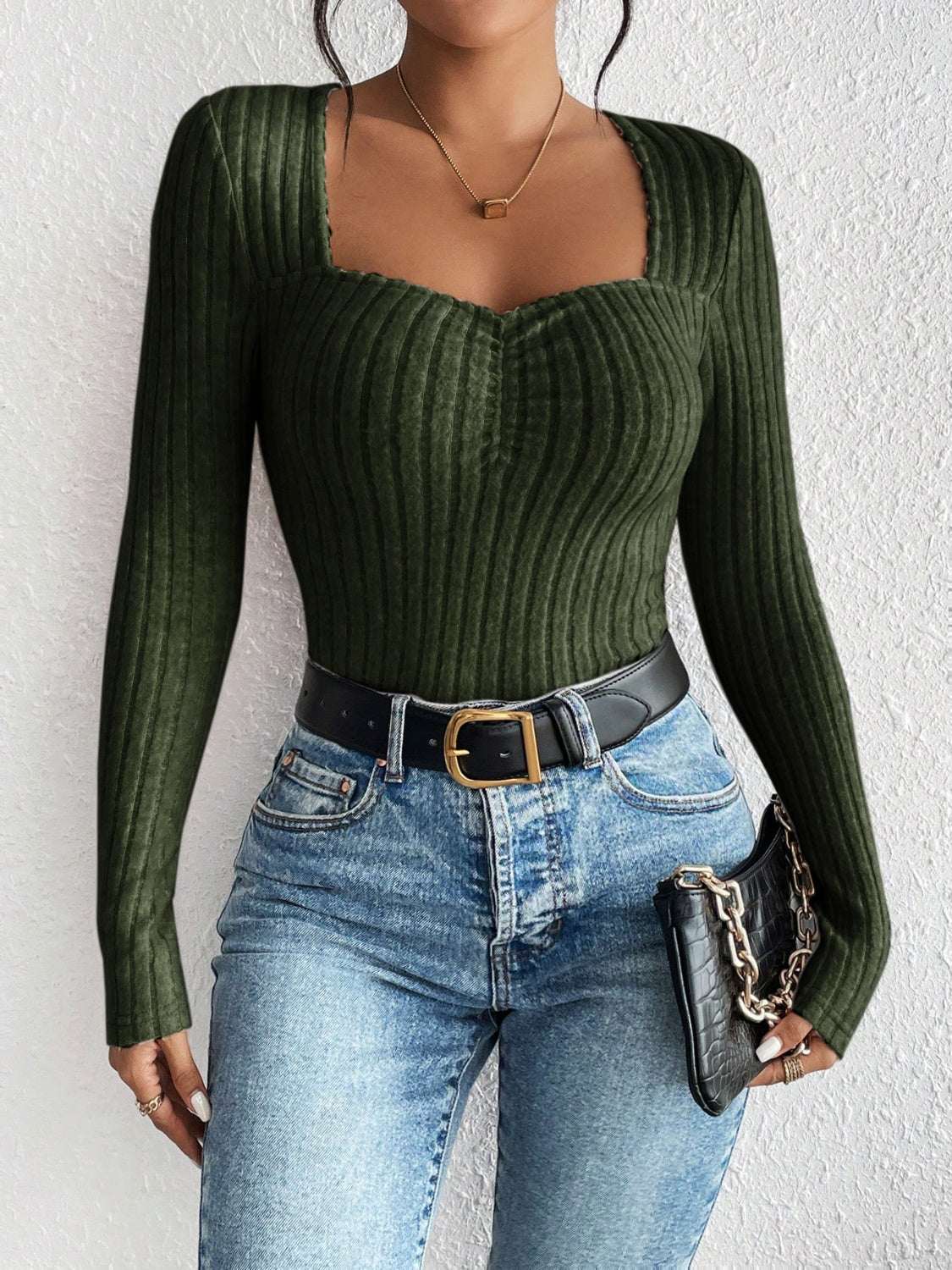 Honey ribbed long sleeve t-shirt in dark green, paired with blue jeans and black belt.