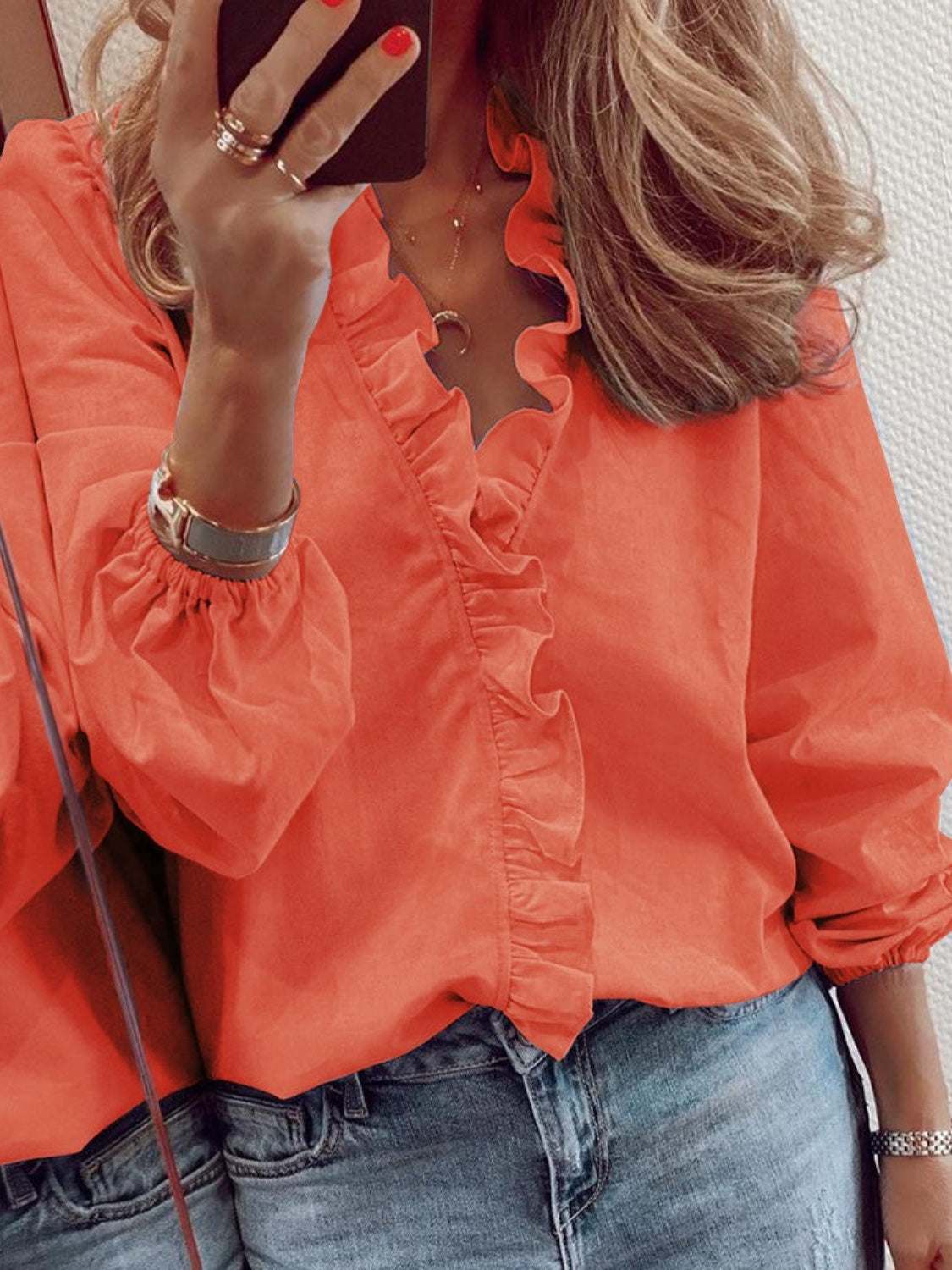 Ruffled V-neck long sleeve blouse in vibrant orange, made of 100% polyester.