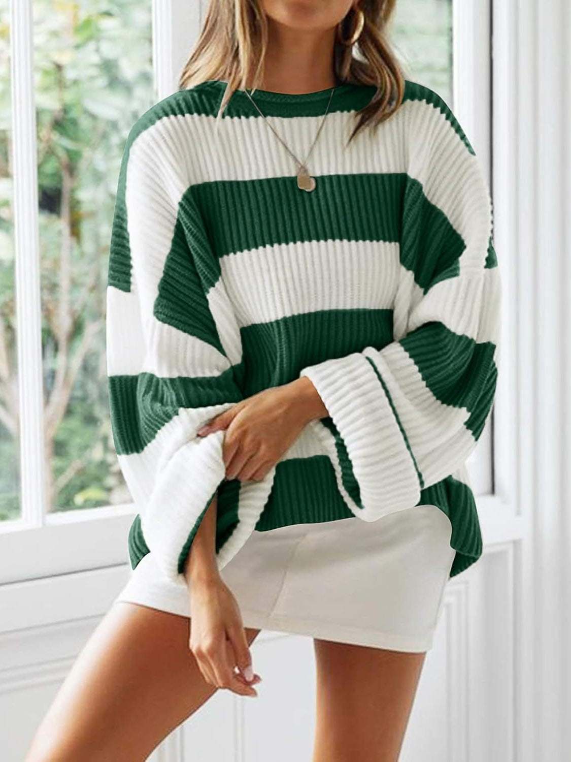 Round neck long sleeve sweater in green and white stripes, slightly stretchy polyester.