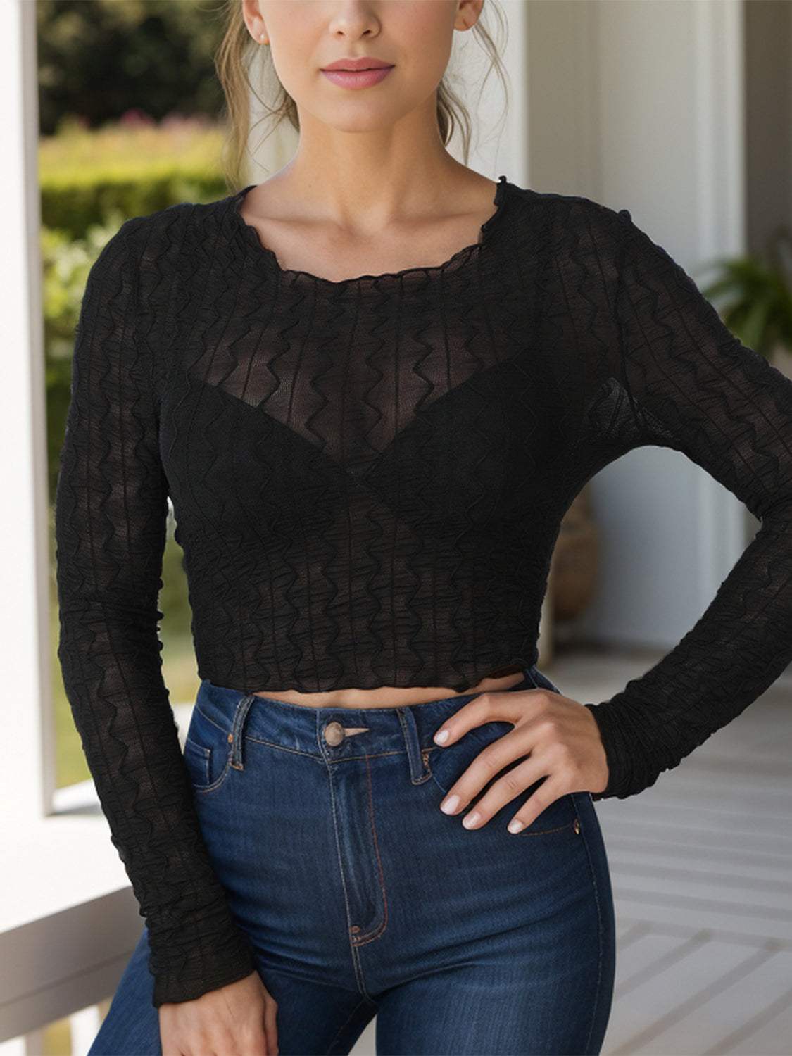 Textured round neck long sleeve top, sheer black fabric, slightly stretchy.