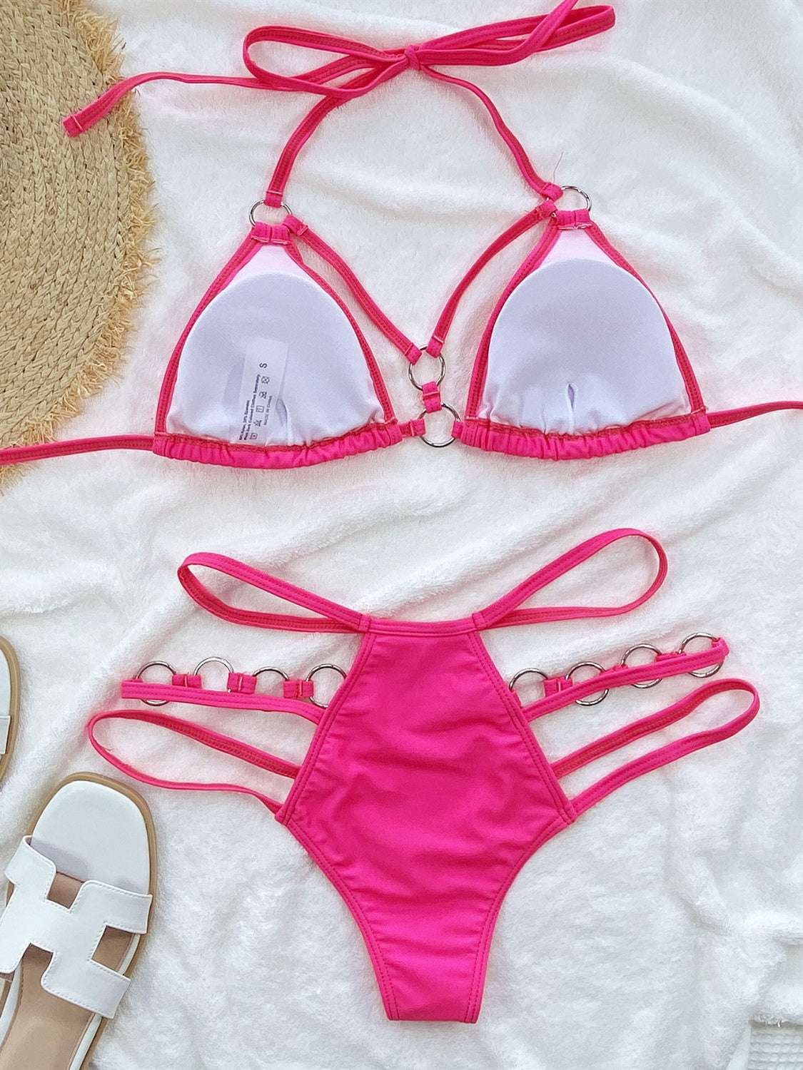 Cutout halter neck two-piece bikini set in pink with removable padding.