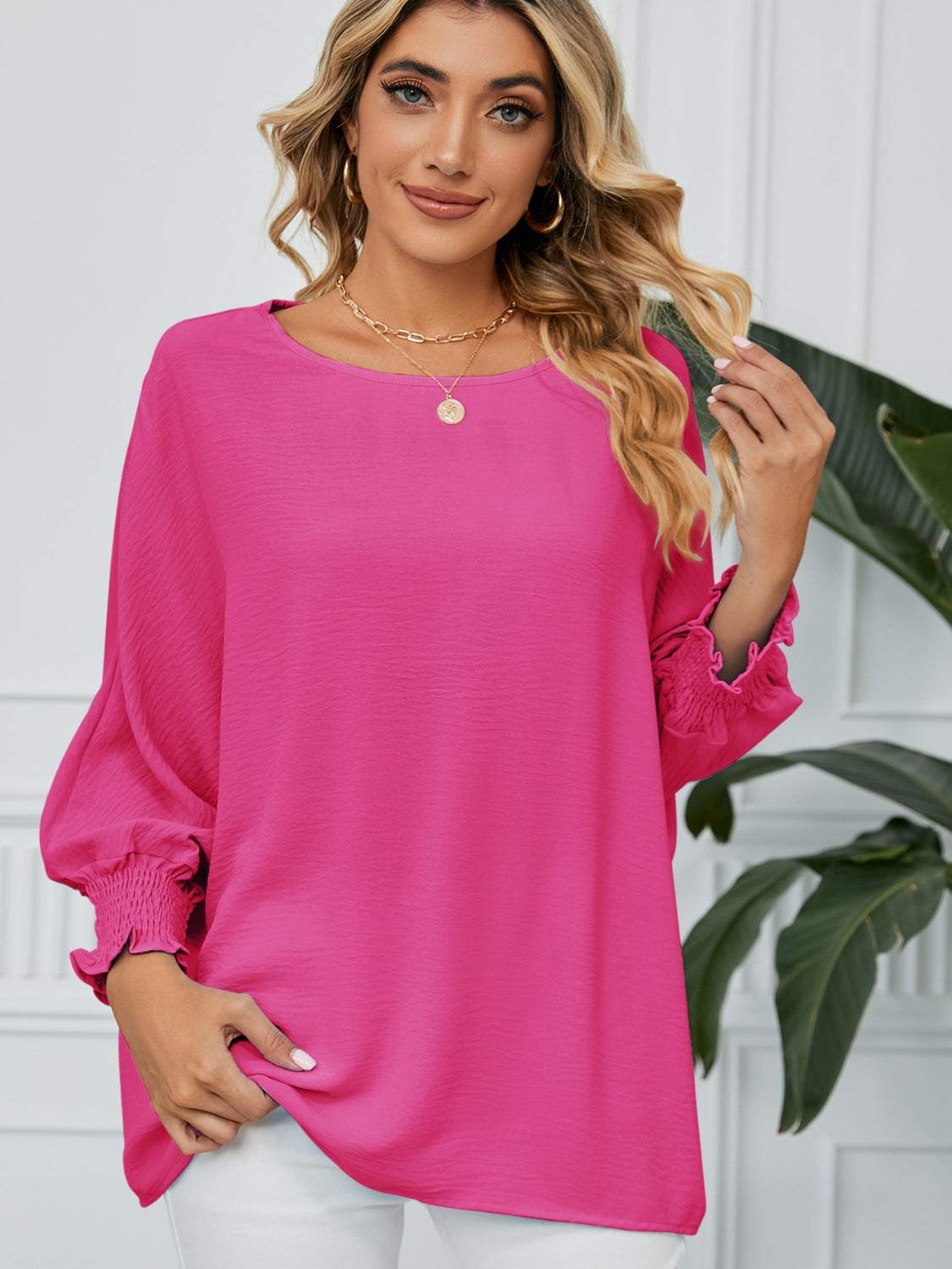 Pink smocked lantern sleeve blouse with round neck, opaque polyester fabric, and no stretch.