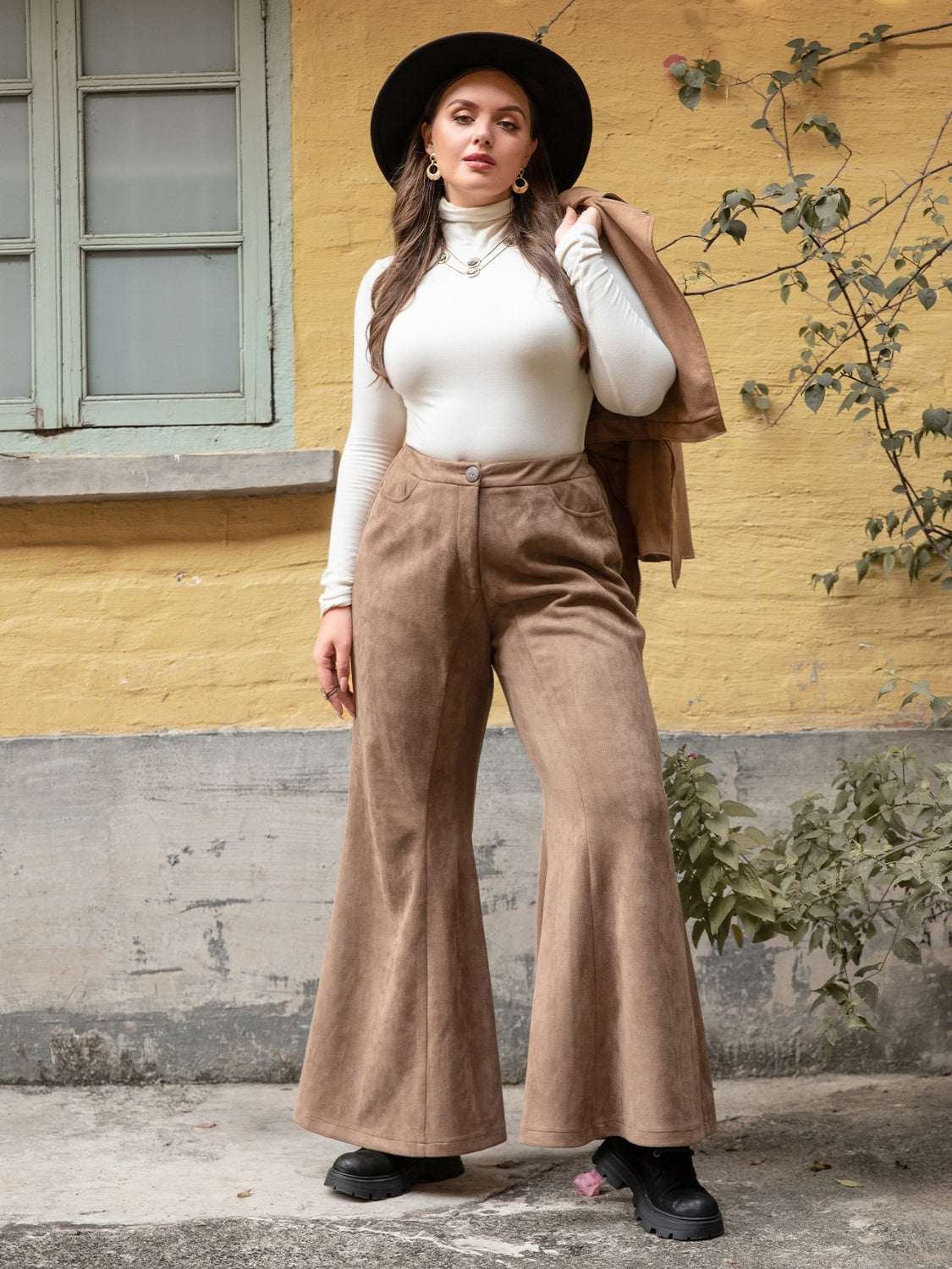 Plus size pocketed flare pants in brown, featuring a comfortable fit and stylish design.