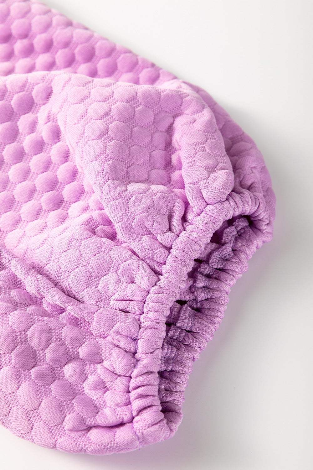 Textured round neck puff sleeve blouse in lavender.