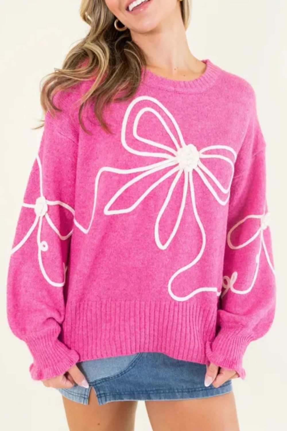 Pink bow round neck dropped shoulder sweater with white bow design, slightly stretchy viscose blend.
