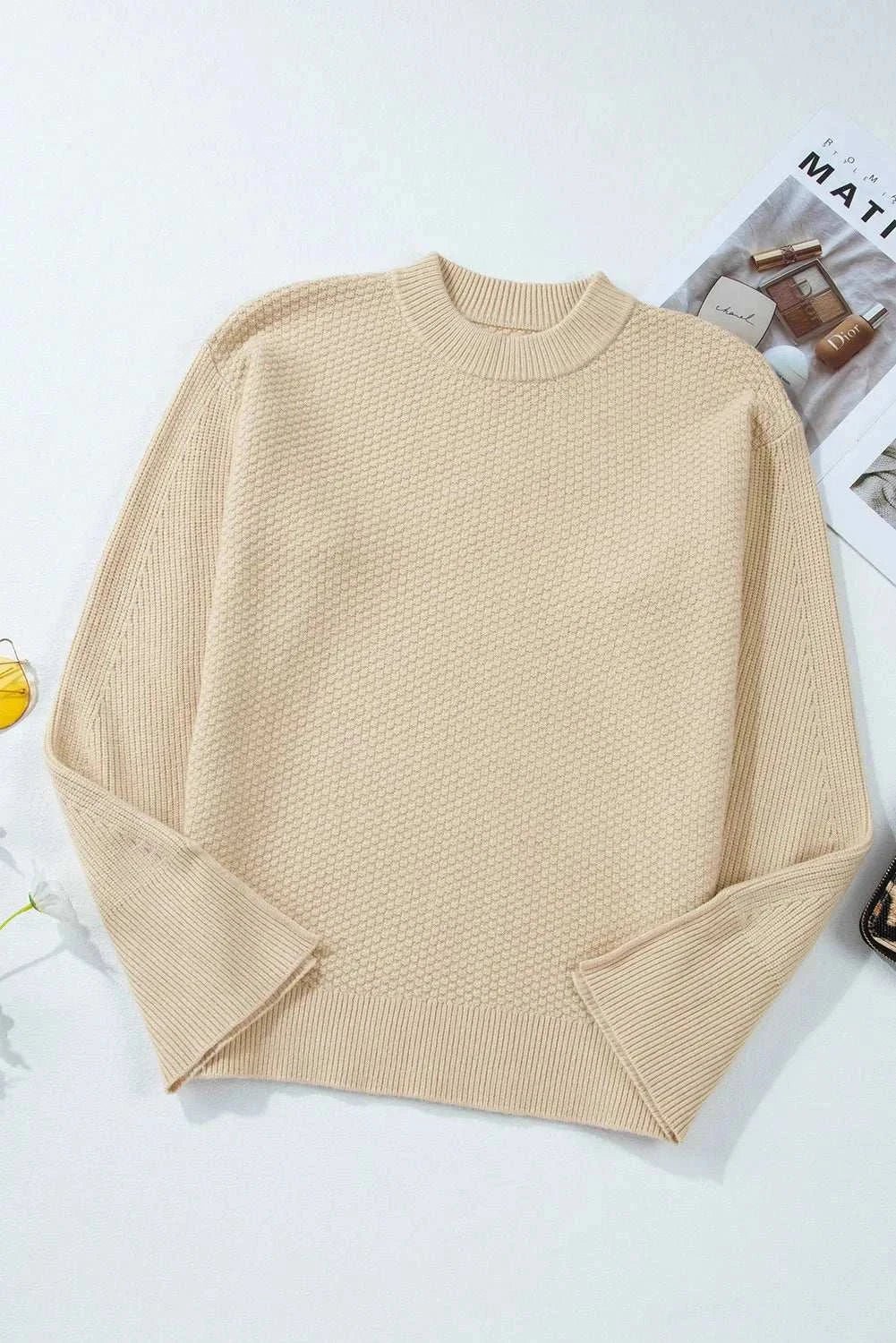 Textured round neck long sleeve sweater in beige with slit detail.