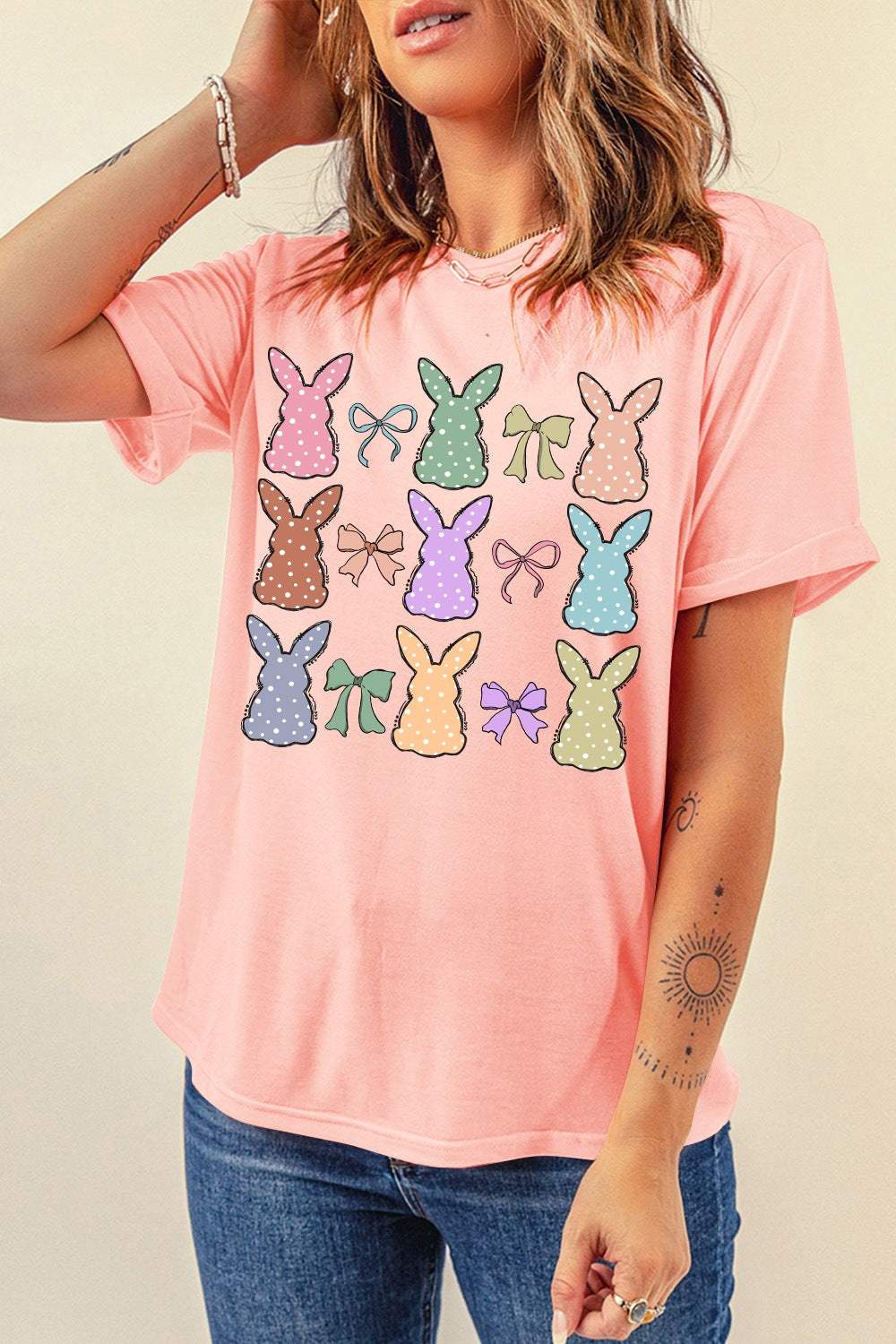 Women's pink short sleeve T-shirt with colorful dotty bunny and bow graphic design.