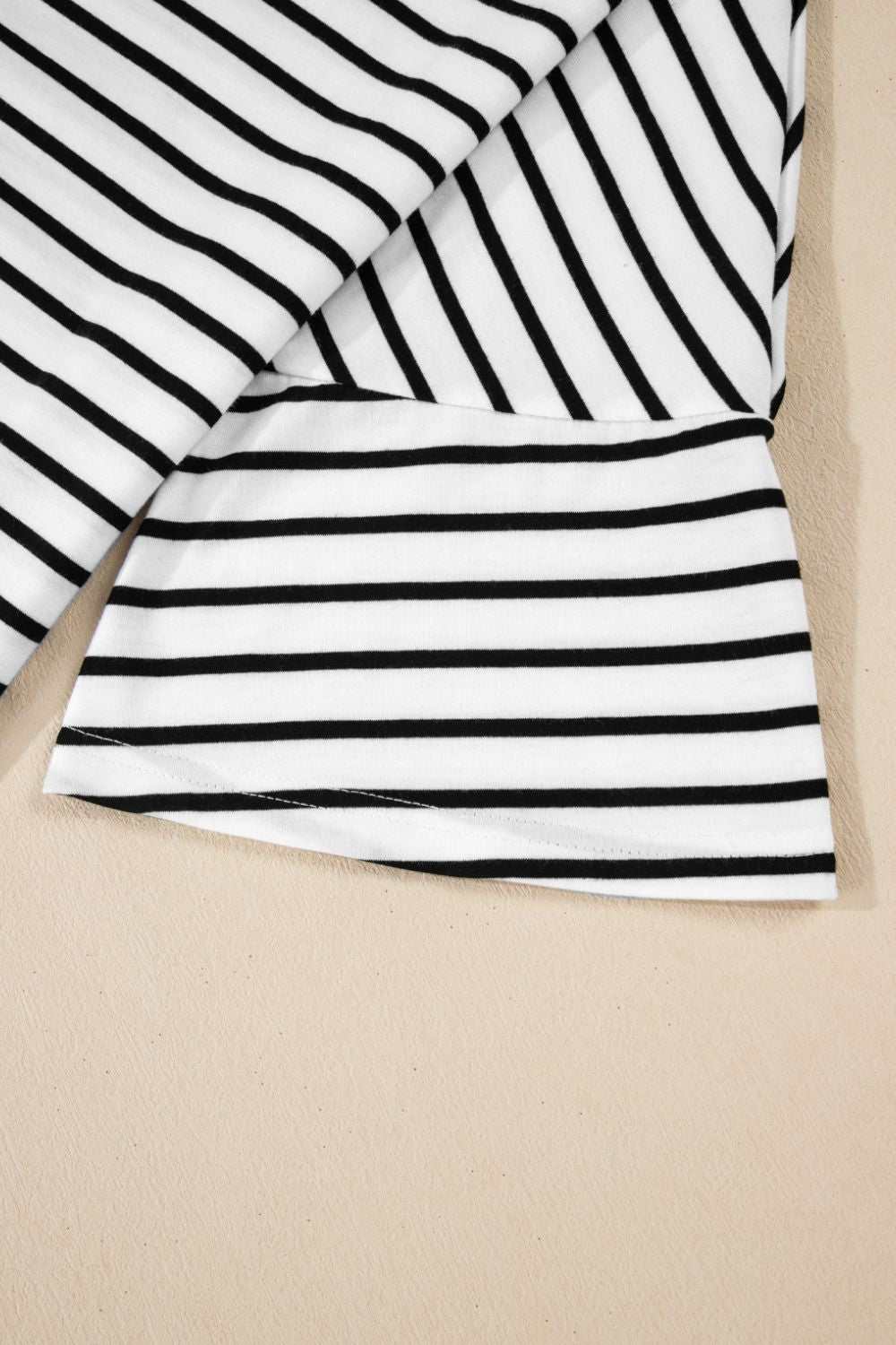 Stripe half sleeve scoop neck top with black and white pattern.
