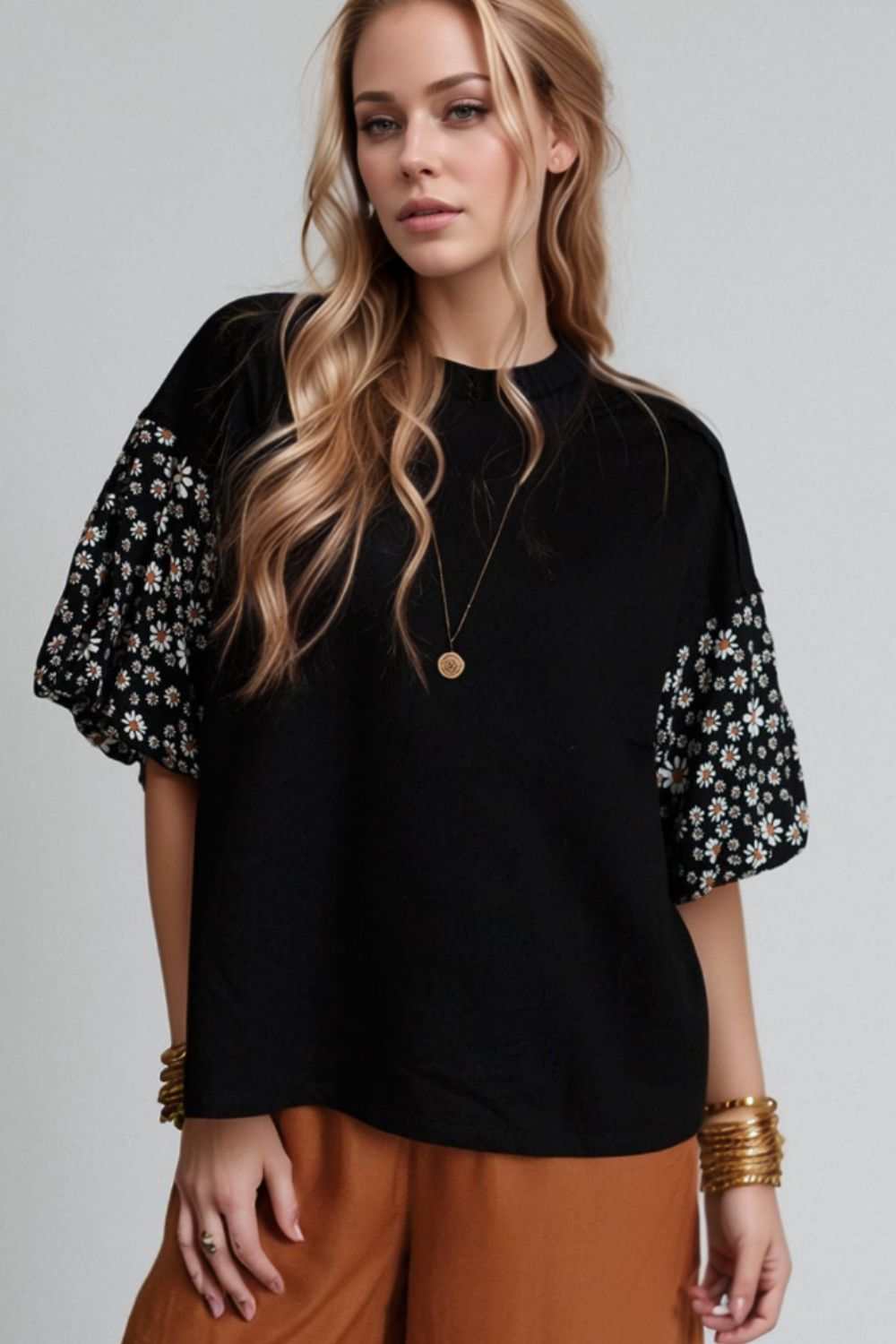 Contrast floral puff sleeve oversized top in black with floral patterned sleeves, slightly stretchy fabric.