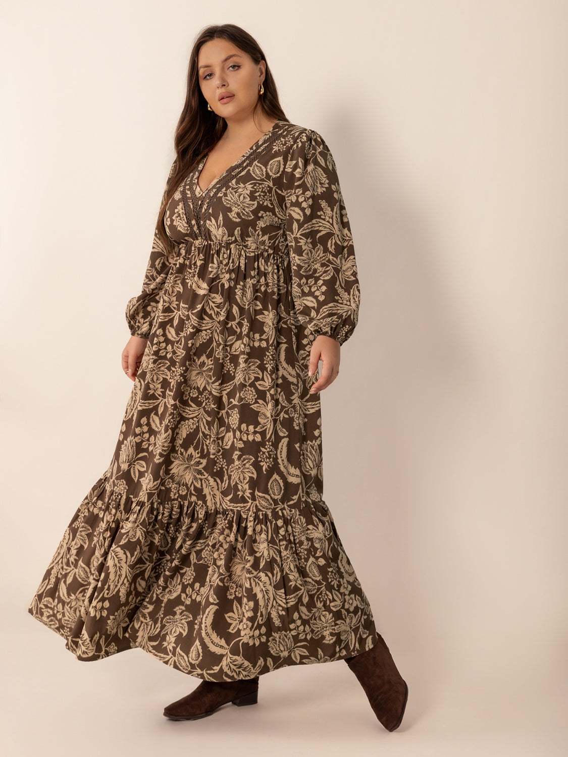 Plus size printed V-neck balloon sleeve maxi dress in brown and beige, model wearing dress.