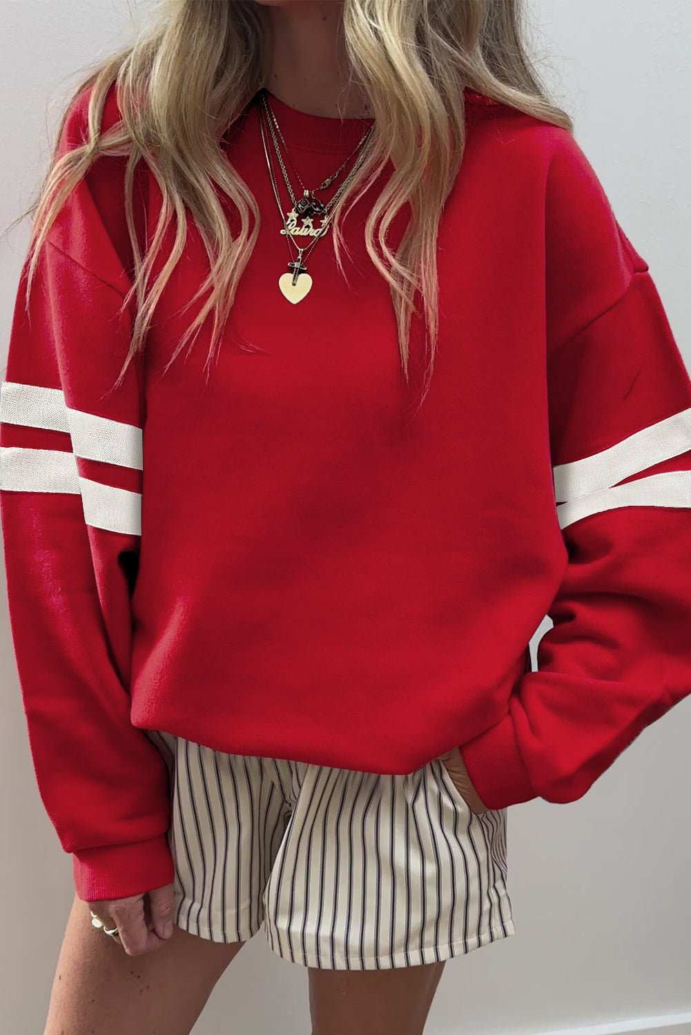 Fiery red oversized sweatshirt with white varsity stripes on drop shoulders and soft fabric