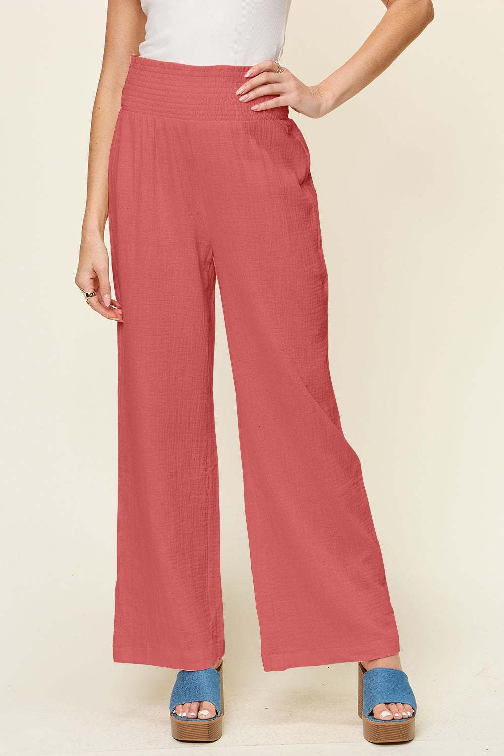 Double Take Full Size Texture Smocked Waist Wide Leg Pants in rose color, 100% cotton, shown on model.