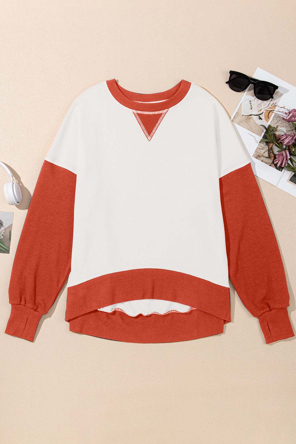 Contrast round neck long sleeve sweatshirt with orange sleeves and white body.