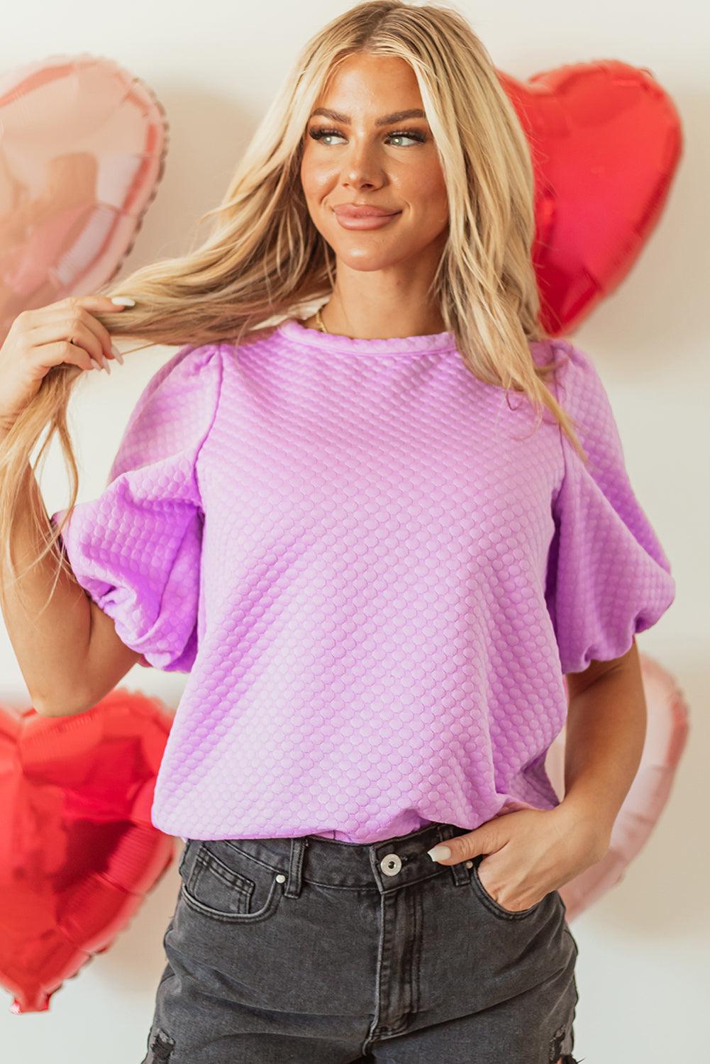 Textured round neck puff sleeve blouse in light purple with slightly stretchy material.
