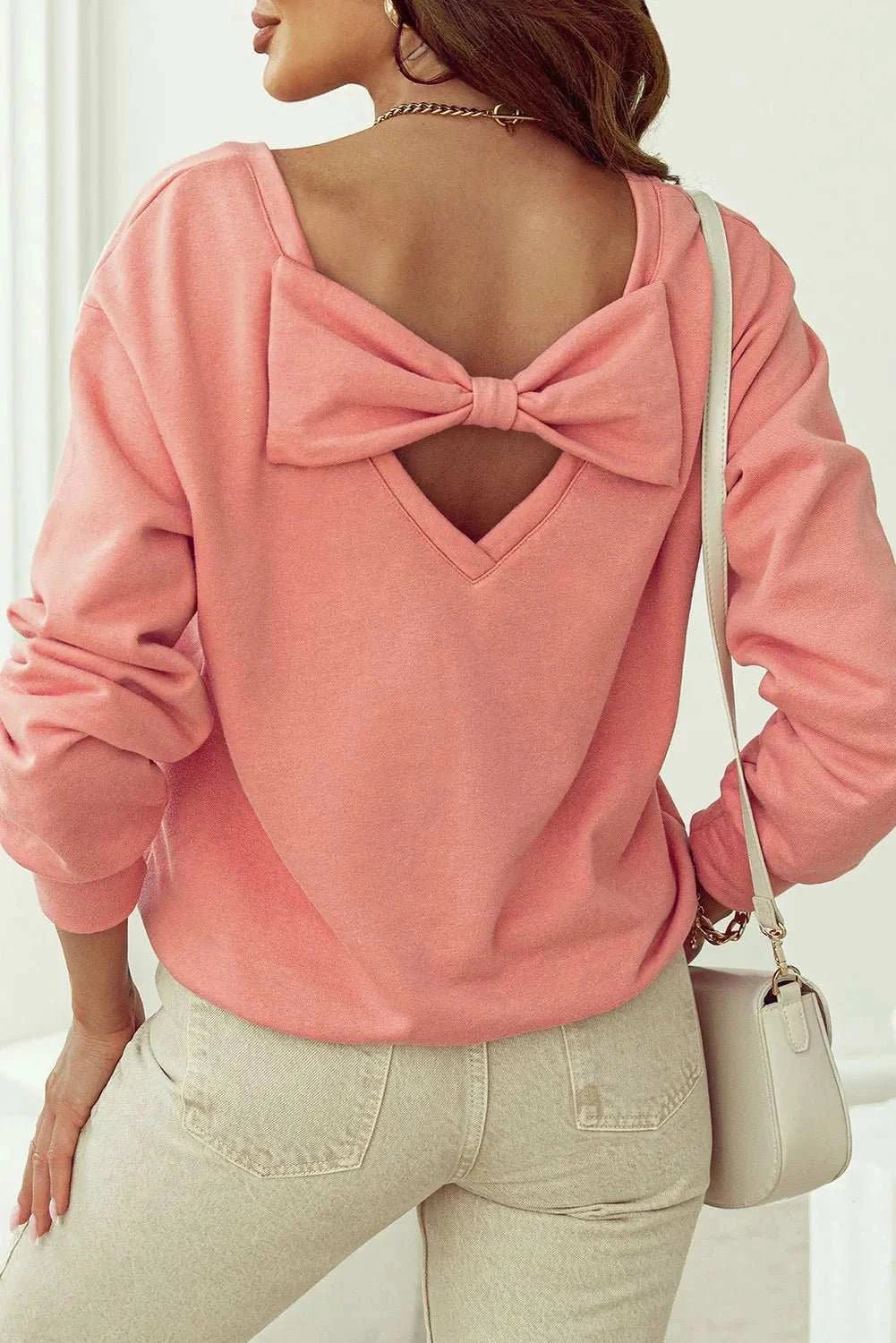 Bow round neck long sleeve sweatshirt with back cutout and large bow detail.