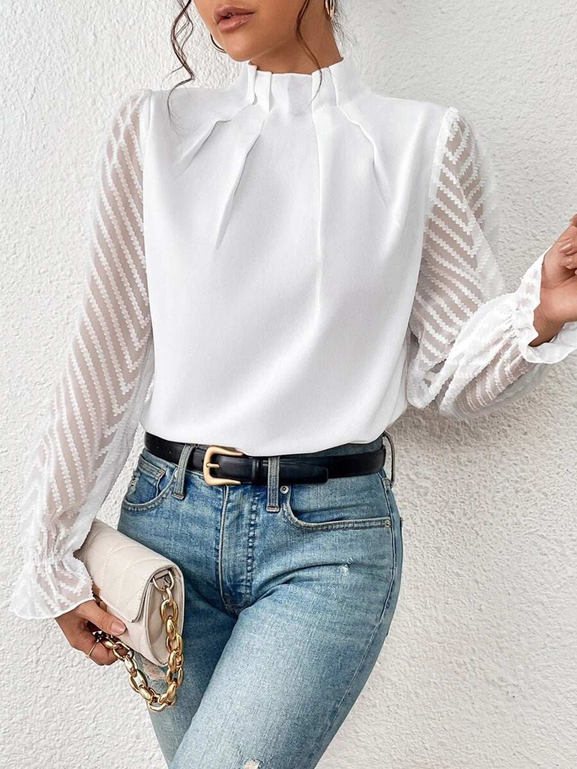Mock neck flounce sleeve blouse, semi-sheer, slightly stretchy polyester, styled with jeans.