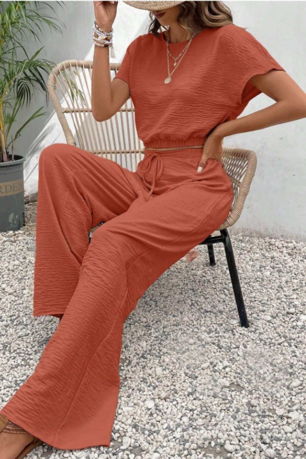 Round neck short sleeve top and pants set in rust, buttoned and tied, no stretch, 100% polyester.