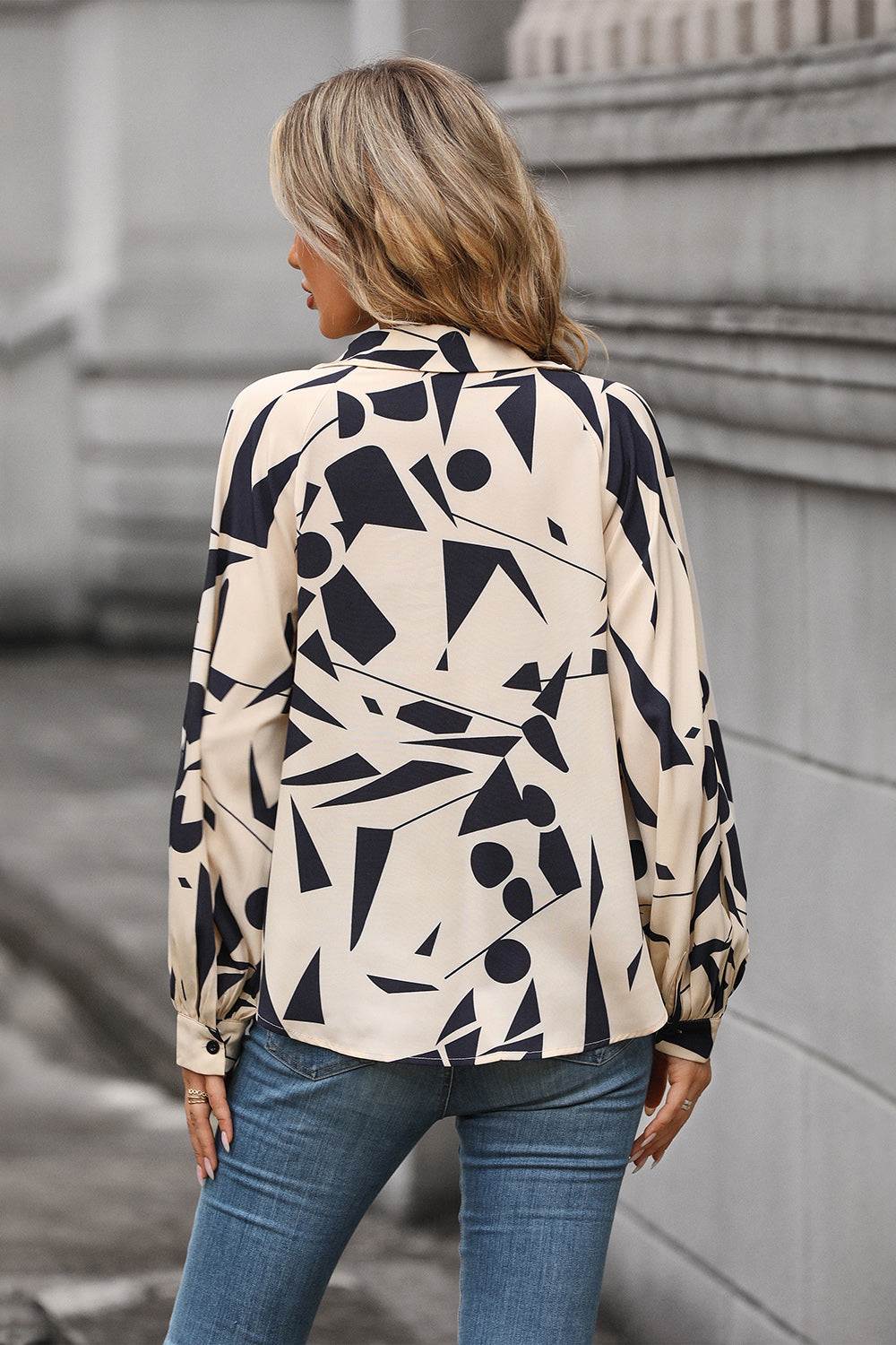 Perfee Printed Johnny Collar Blouse with geometric pattern, long sleeves, and relaxed fit, made of 100% polyester.