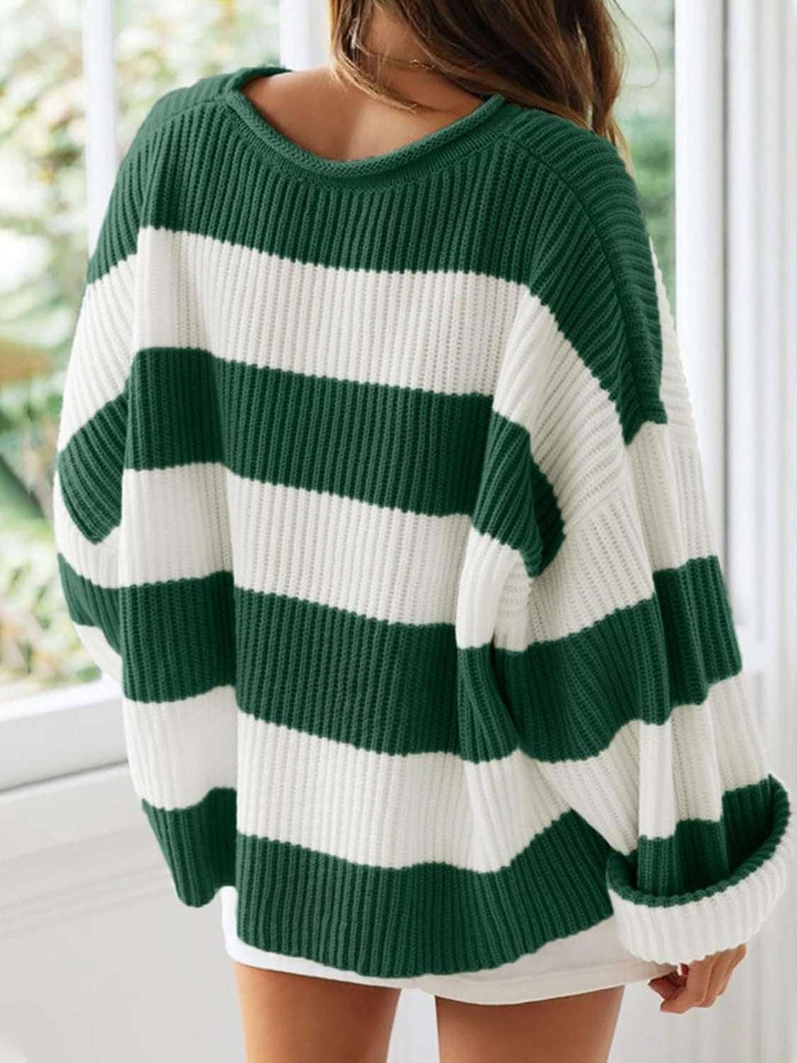 Round neck long sleeve sweater in green and white stripes, slightly stretchy polyester.