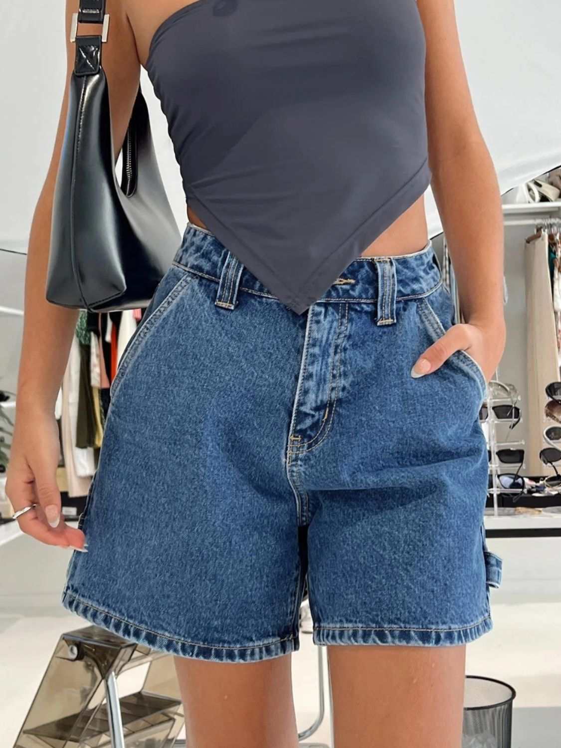 Washed high rise denim shorts with pockets and no stretch, made from 95% rayon and 5% polyester.