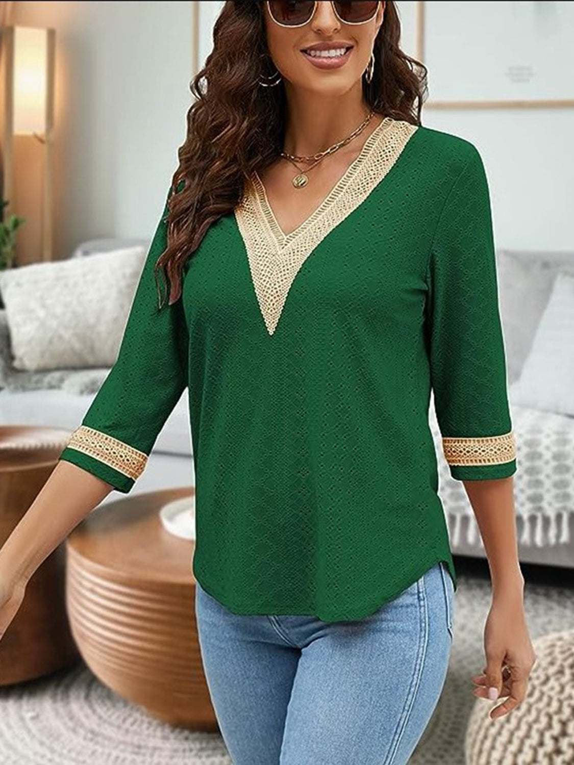 V-Neck Eyelet Blouse in green with lace trim, worn by a model with blue jeans.